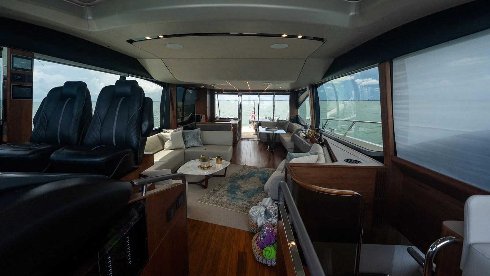 The salon features luxurious seating and panoramic windows, offering a comfortable and elegant space for relaxation. aboard PARAGON Yacht for Sale