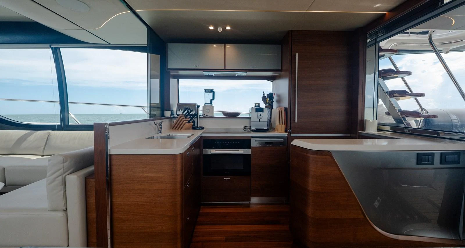 The yacht's galley features modern appliances and sleek wooden cabinetry, offering a stylish and functional space for meal preparation. aboard PARAGON Yacht for Sale