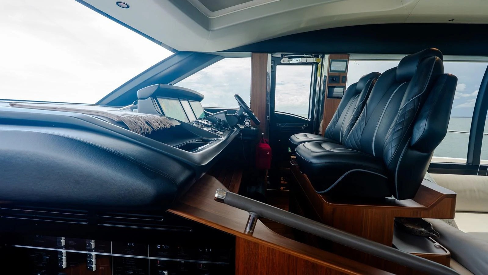 The helm station features luxurious leather seating and state-of-the-art navigation equipment. aboard PARAGON Yacht for Sale