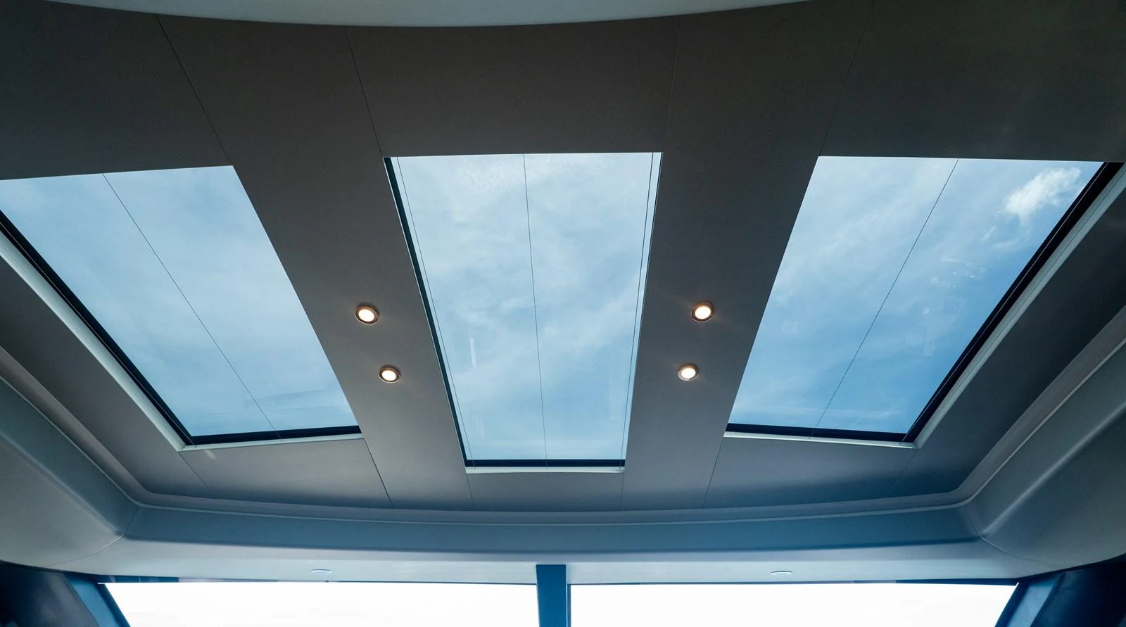 The yacht features a sleek skylight with multiple glass panels, allowing natural light to flood the interior. aboard PARAGON Yacht for Sale