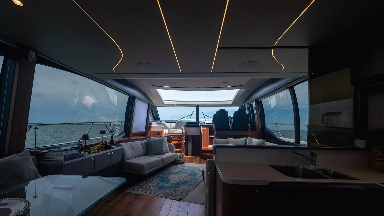The yacht's salon features modern furnishings and expansive windows offering stunning sea views. aboard PARAGON Yacht for Sale
