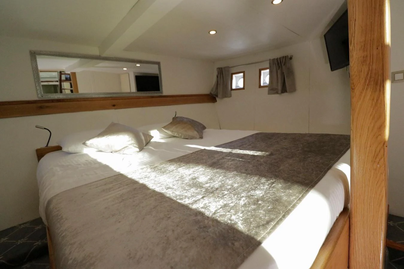 A cozy stateroom with a large bed and soft lighting. aboard 21 M MOTORSAILOR Yacht for Sale