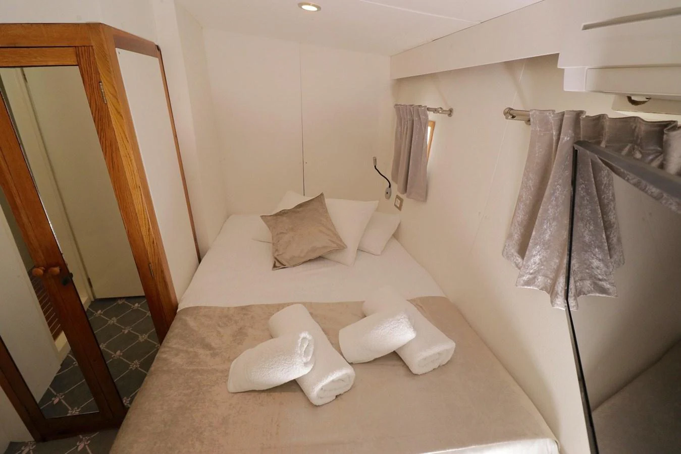 A cozy stateroom featuring a comfortable bed with fresh linens and towels. aboard 21 M MOTORSAILOR Yacht for Sale