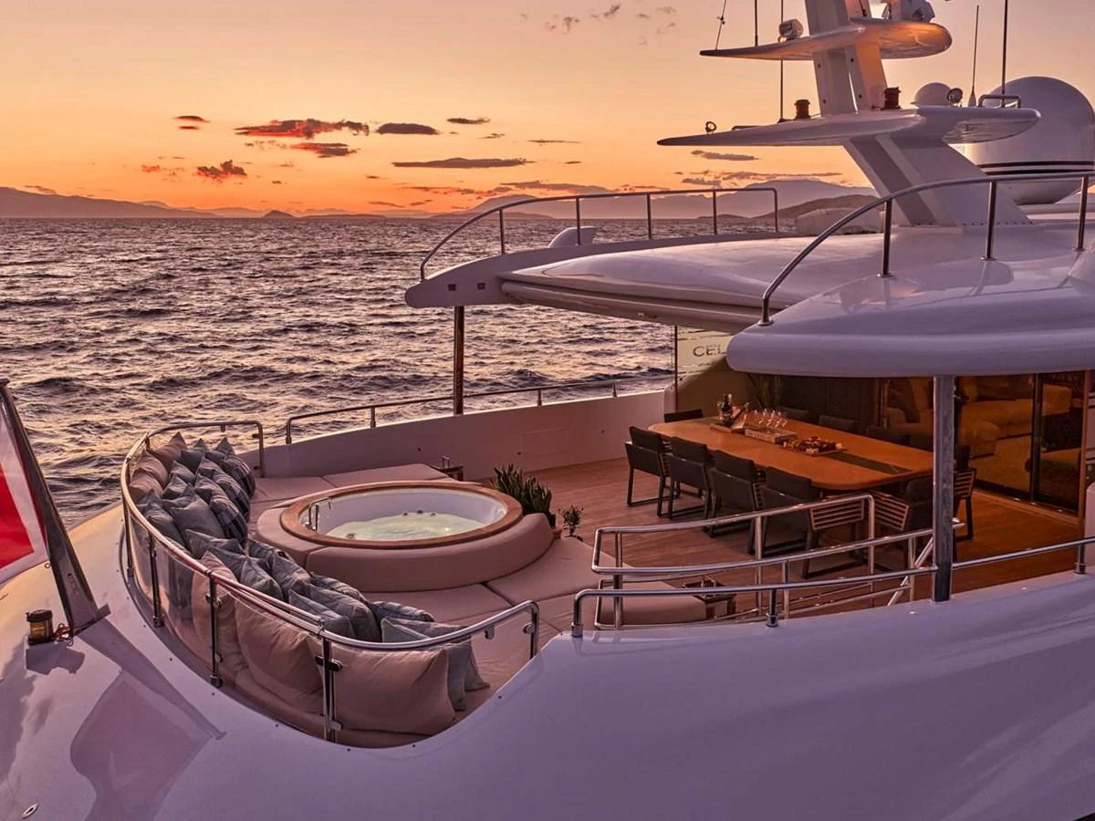 The aft deck features a luxurious jacuzzi and a spacious dining area, perfect for enjoying sunsets at sea. aboard ULYSSES Yacht for Sale