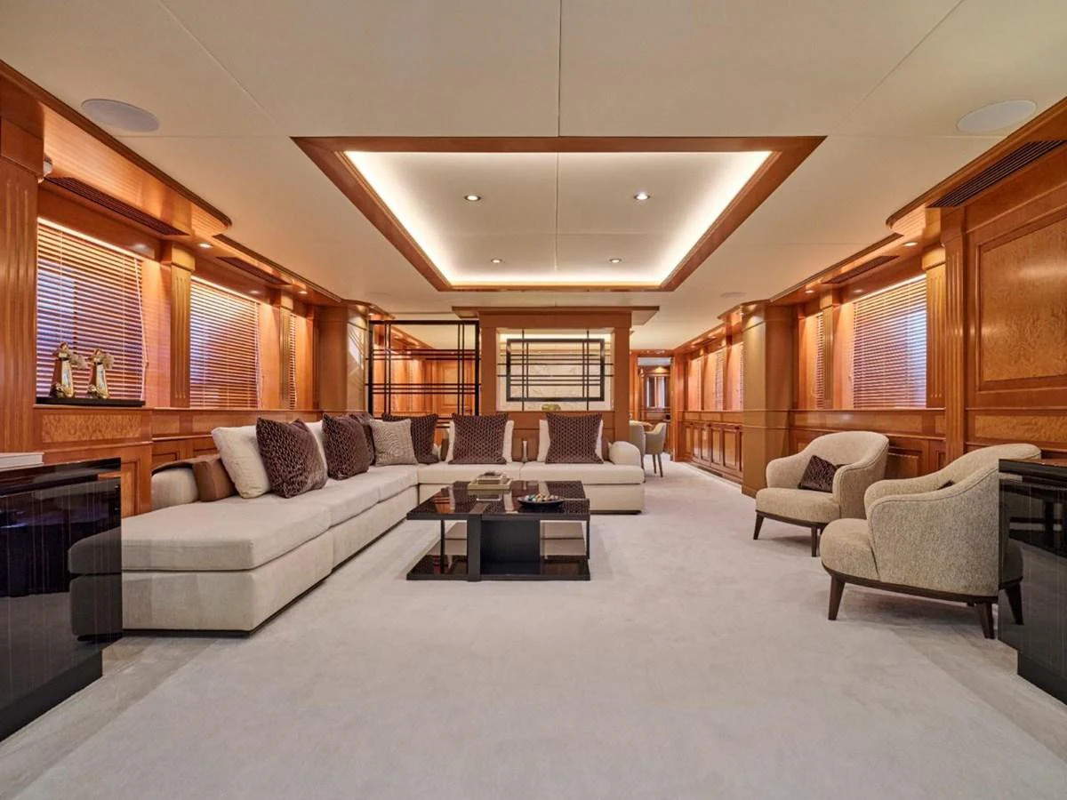 The yacht's salon features luxurious seating and elegant wood paneling. aboard ULYSSES Yacht for Sale