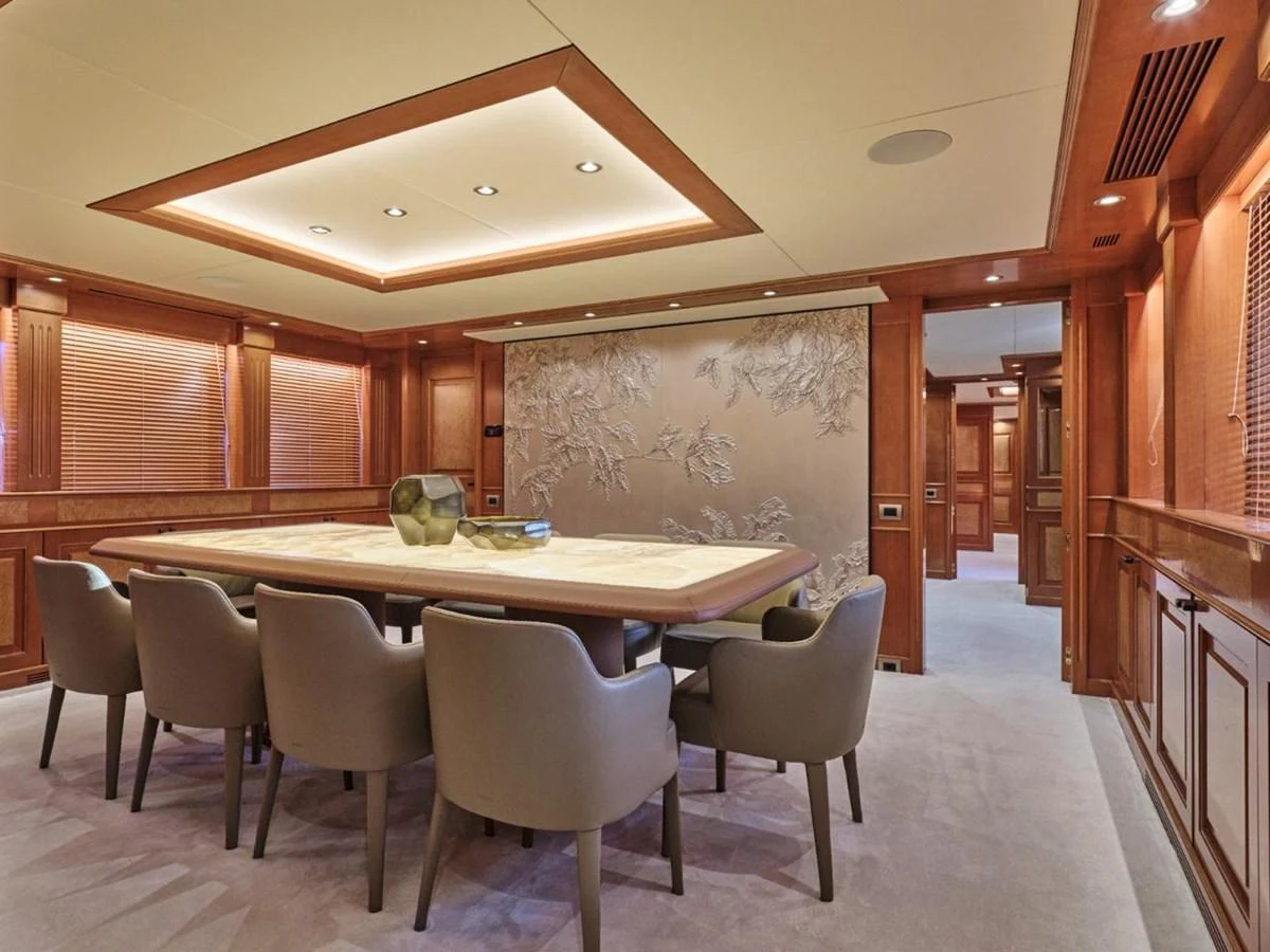 The yacht's dining area features elegant seating and sophisticated lighting. aboard ULYSSES Yacht for Sale