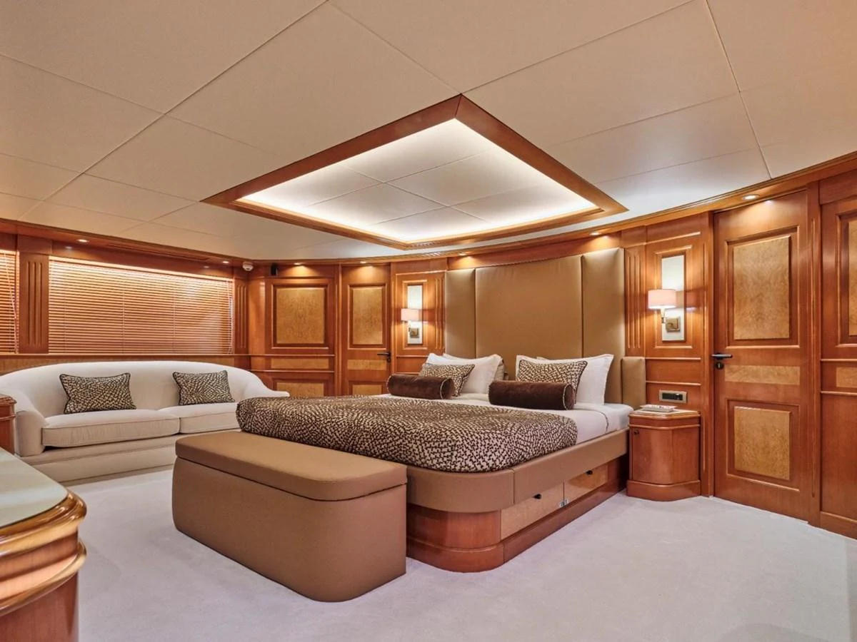 The master stateroom features luxurious wood paneling and elegant furnishings. aboard ULYSSES Yacht for Sale