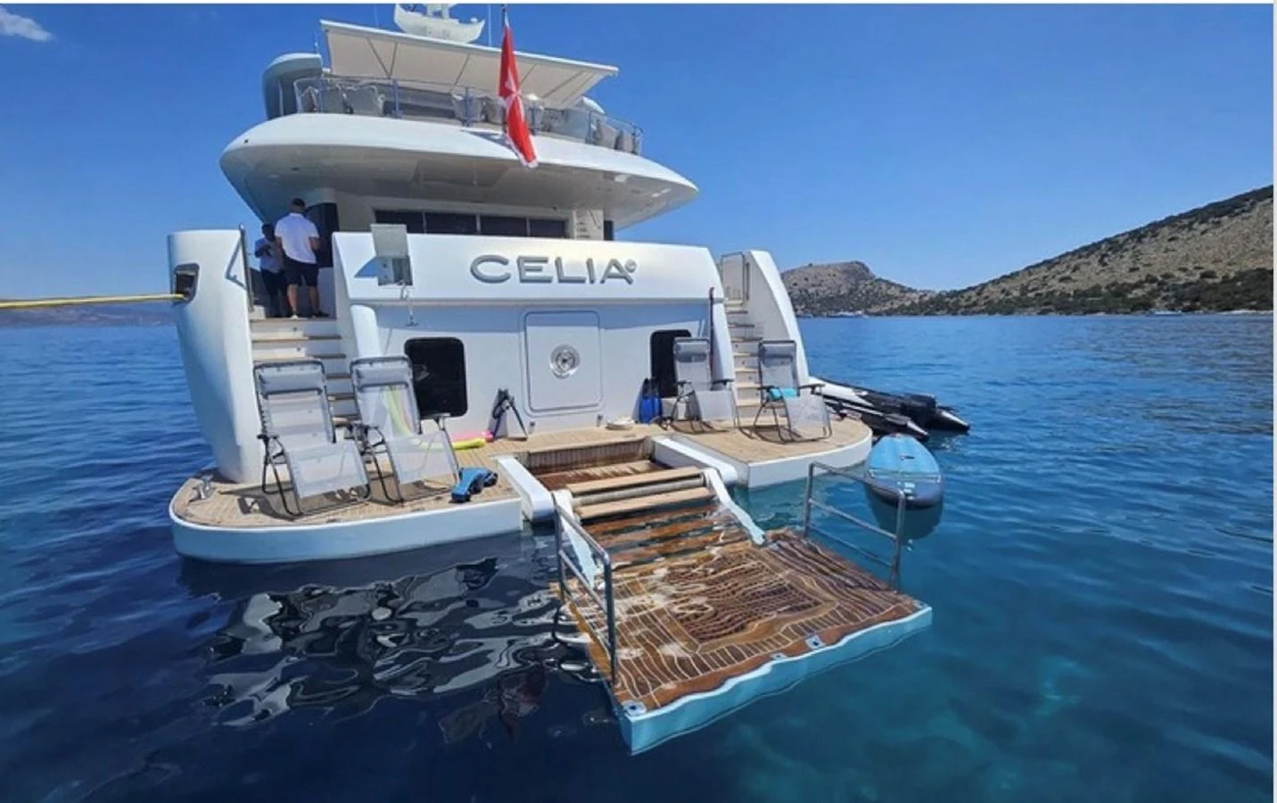 The yacht's aft deck features a spacious swim platform with easy access to the water, perfect for enjoying the serene surroundings. aboard ULYSSES Yacht for Sale
