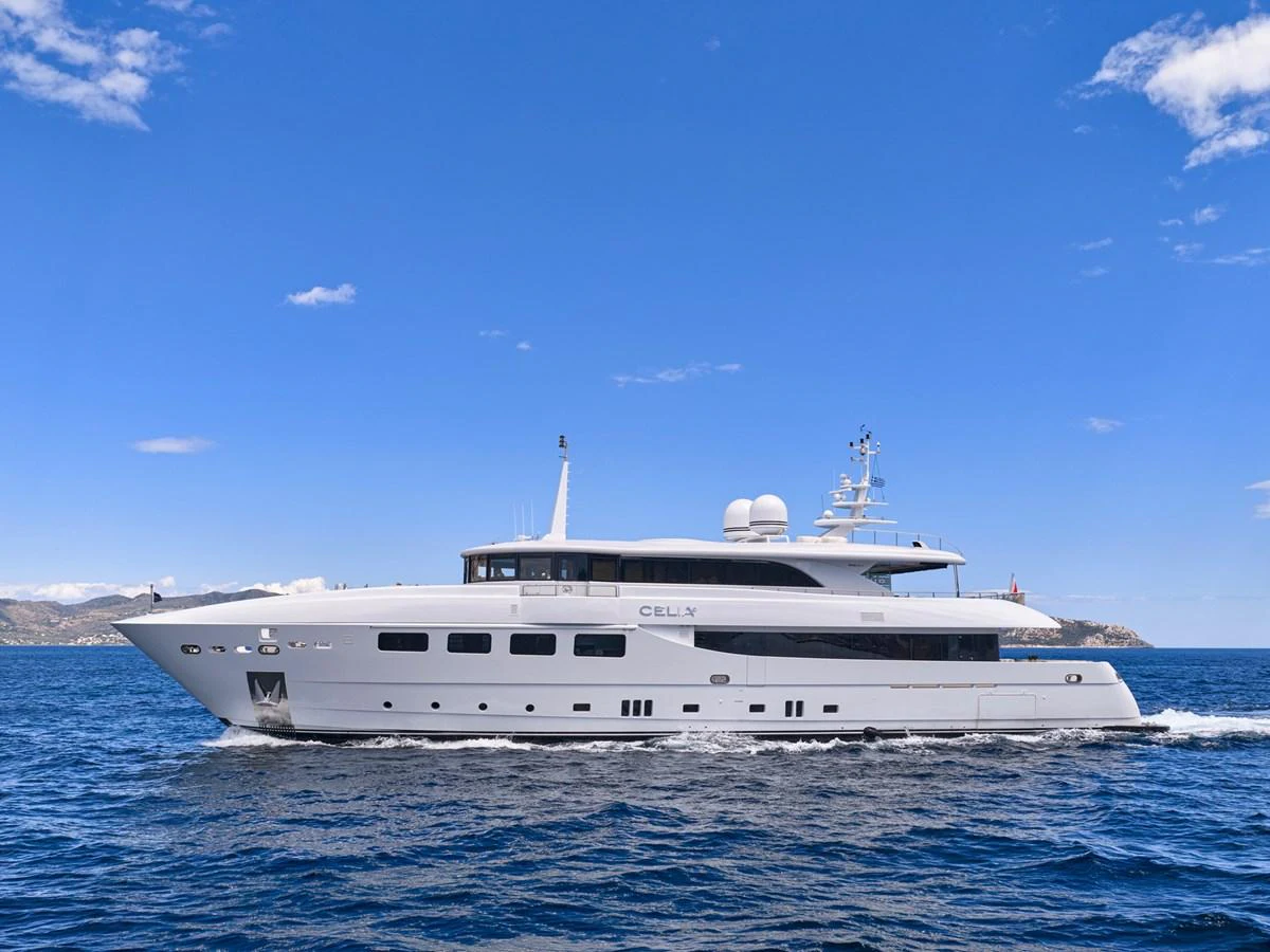 A sleek and modern yacht cruises gracefully on the open water under a clear blue sky. aboard ULYSSES Yacht for Sale