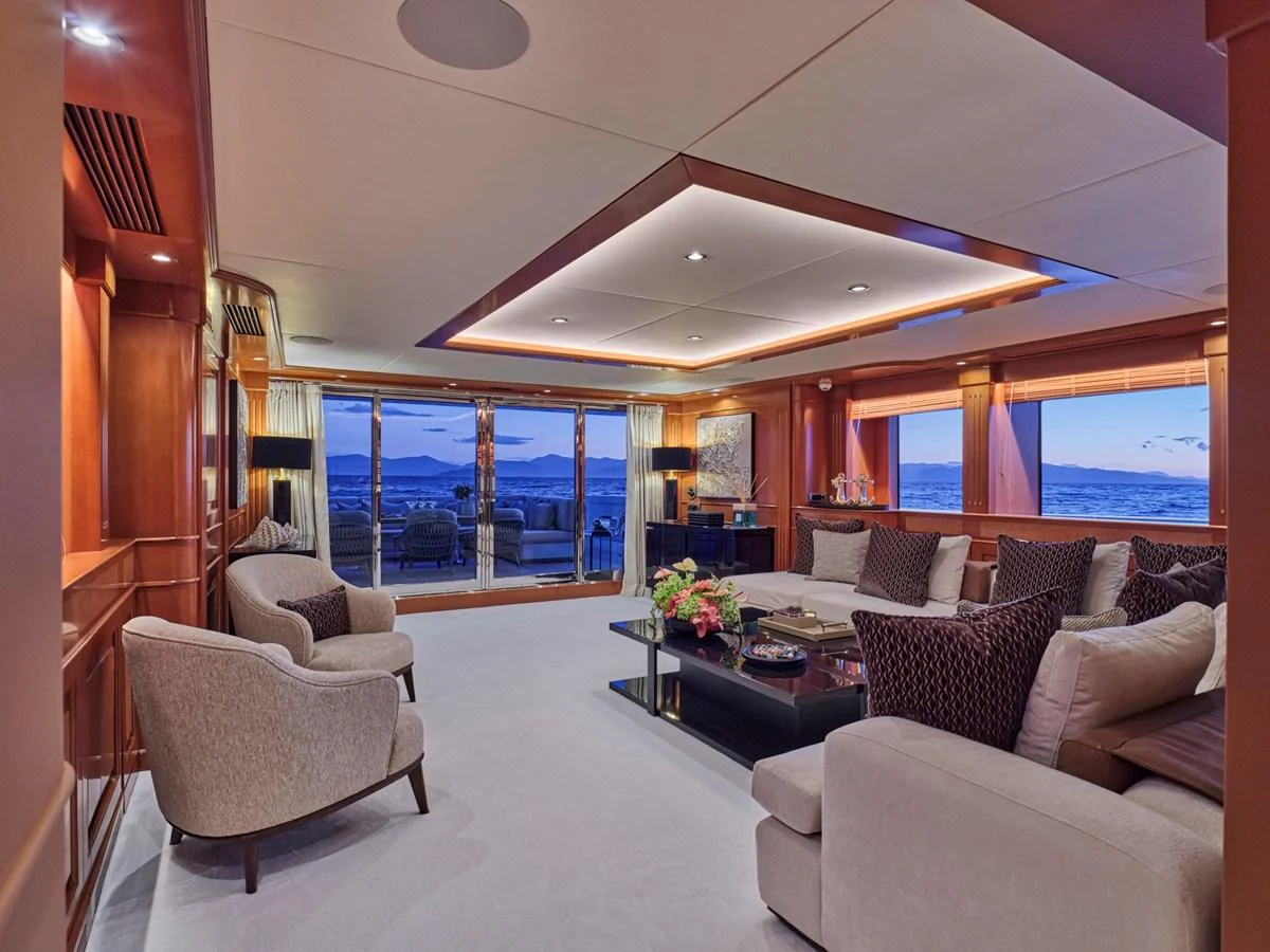 The yacht's salon features elegant seating with panoramic views and sophisticated lighting. aboard ULYSSES Yacht for Sale