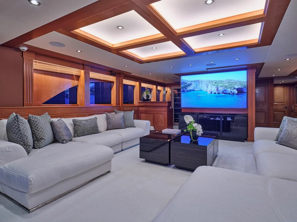 The salon features plush seating, a large TV, and elegant wood accents, creating a luxurious and comfortable atmosphere. aboard ULYSSES Yacht for Sale