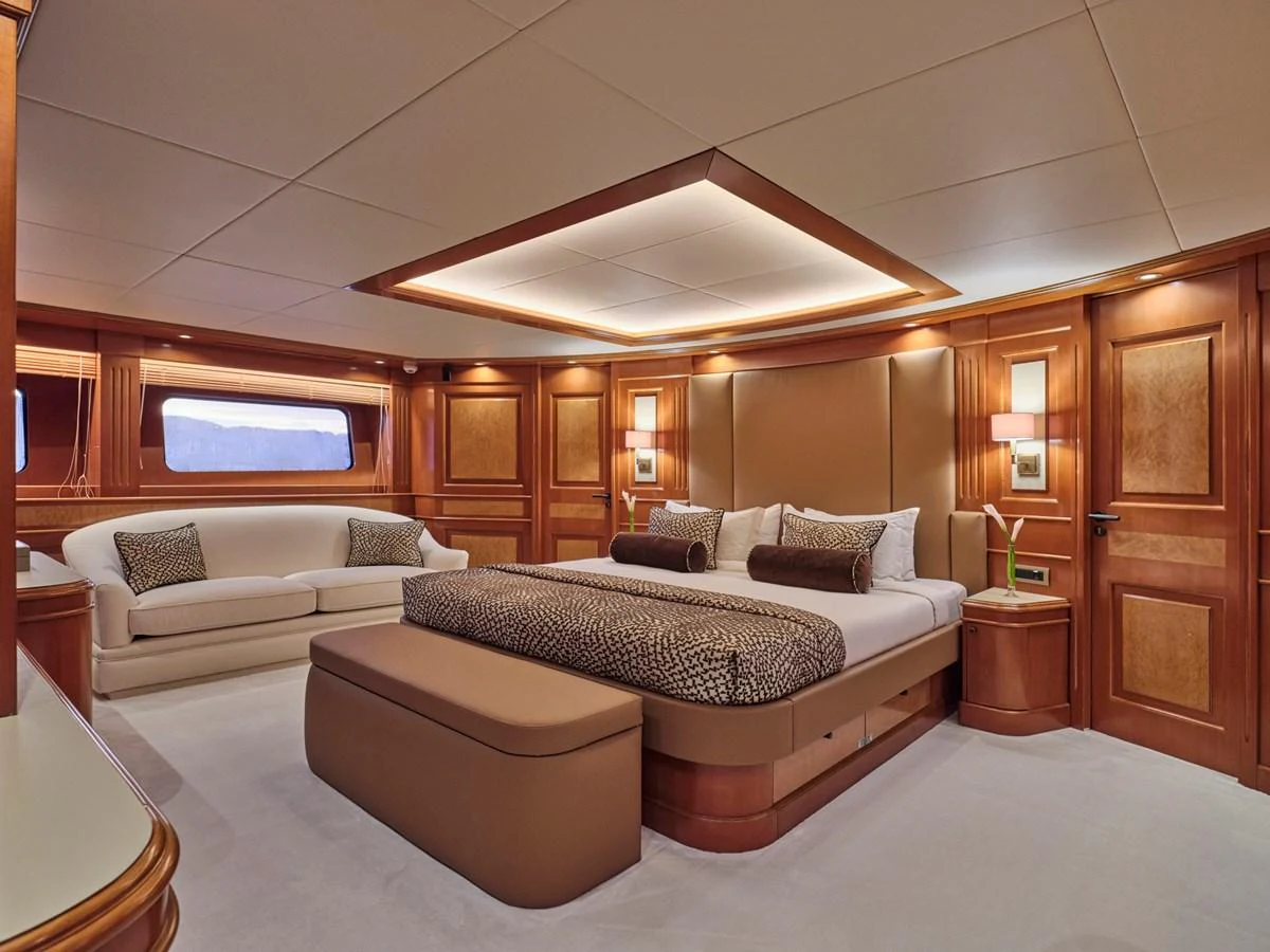 The master stateroom offers luxurious comfort with elegant wood paneling and plush furnishings. aboard ULYSSES Yacht for Sale