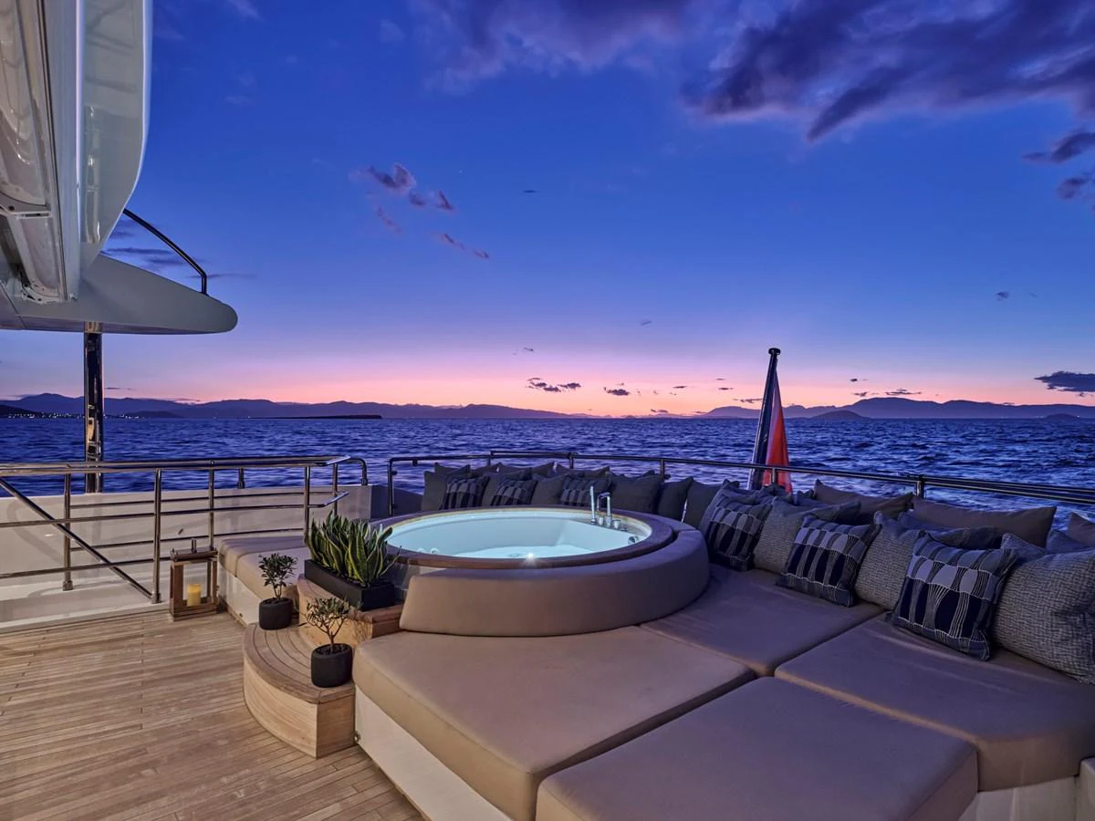 The sundeck features a luxurious jacuzzi surrounded by comfortable seating, perfect for relaxation at sunset. aboard ULYSSES Yacht for Sale