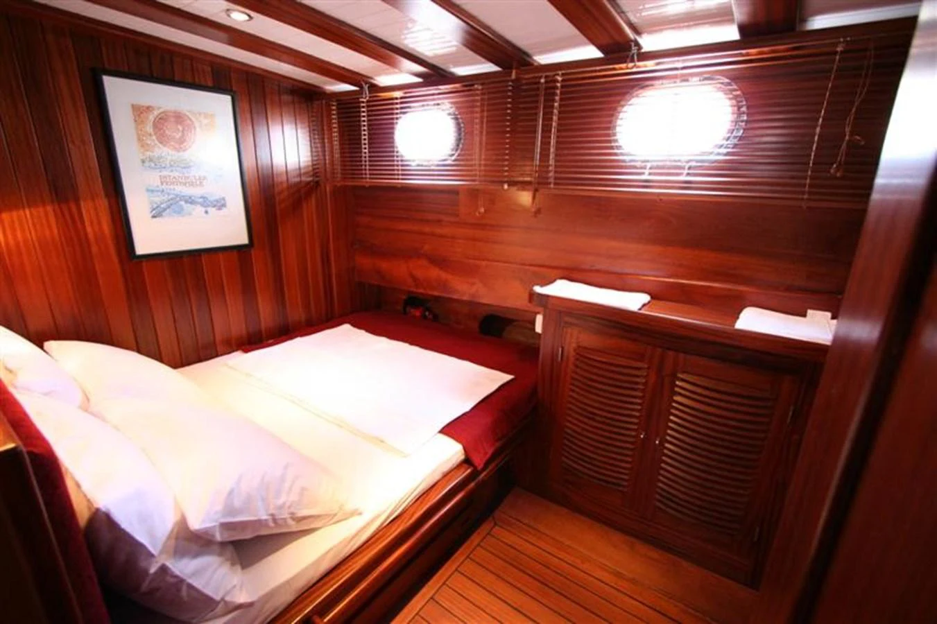 A cozy stateroom with wooden paneling and a comfortable bed. aboard TRIPPIN Yacht for Sale
