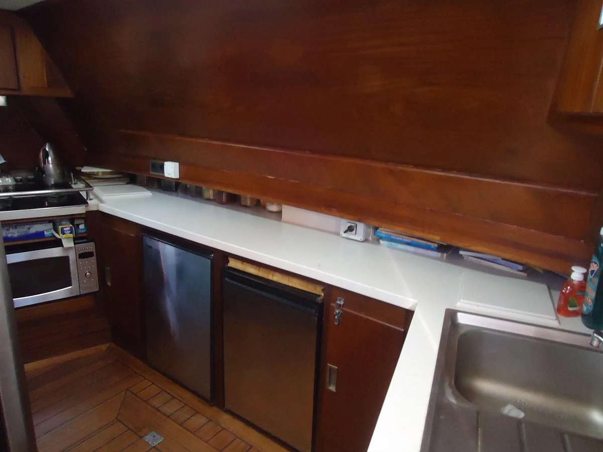The galley features modern appliances and ample counter space for meal preparation. aboard TRIPPIN Yacht for Sale