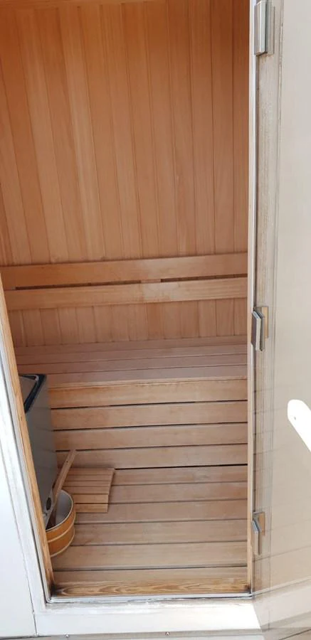 A cozy wooden sauna provides a relaxing retreat onboard. aboard LEOPARD 105 FT Yacht for Sale