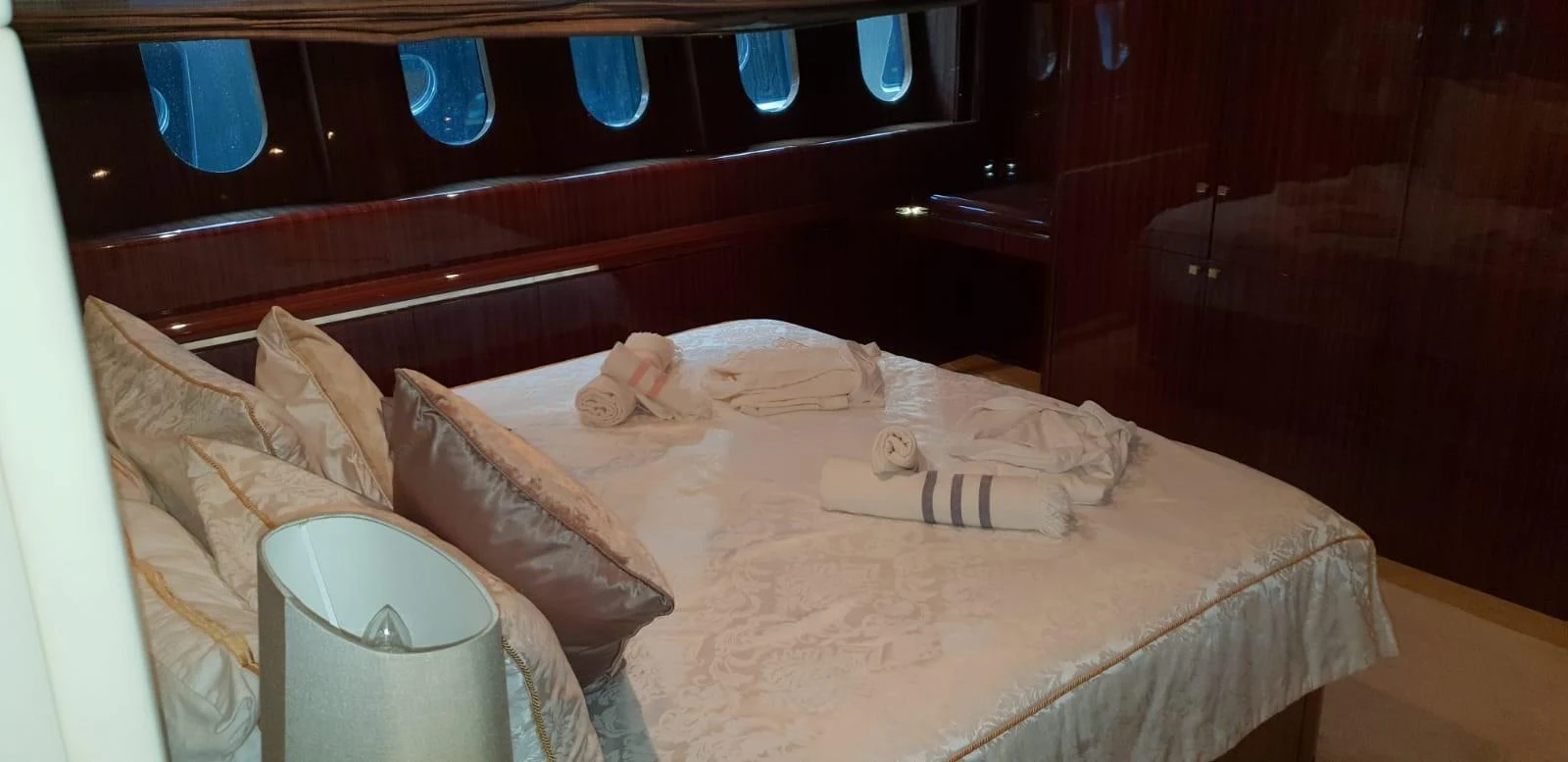 A luxurious stateroom featuring a comfortable bed with elegant linens and ample natural light from the windows. aboard LEOPARD 105 FT Yacht for Sale