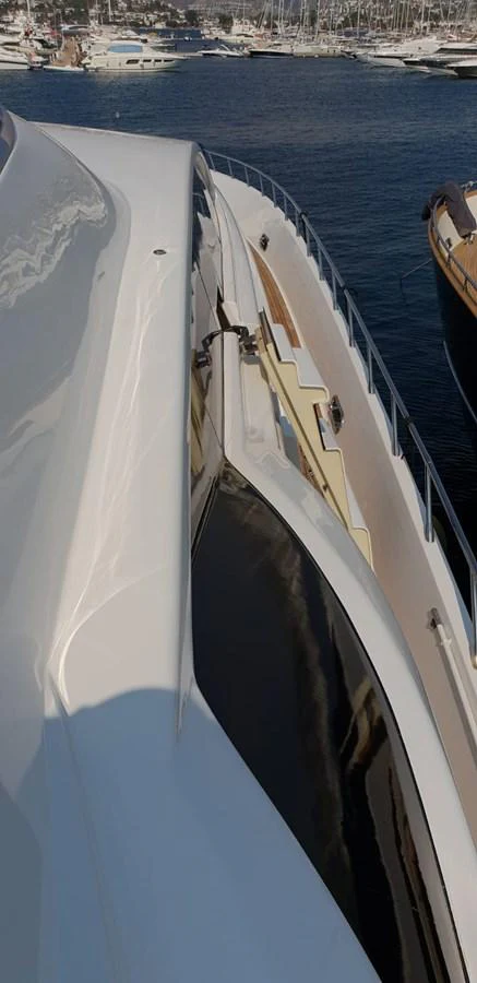 A close-up view of the yacht's sleek exterior detailing and deck area. aboard LEOPARD 105 FT Yacht for Sale