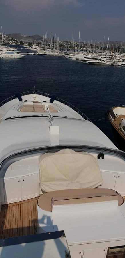 The yacht's bow area is showcased with a view of the marina in the background. aboard LEOPARD 105 FT Yacht for Sale