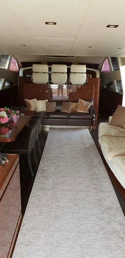 The yacht's salon features elegant seating and a dining area with luxurious finishes. aboard LEOPARD 105 FT Yacht for Sale