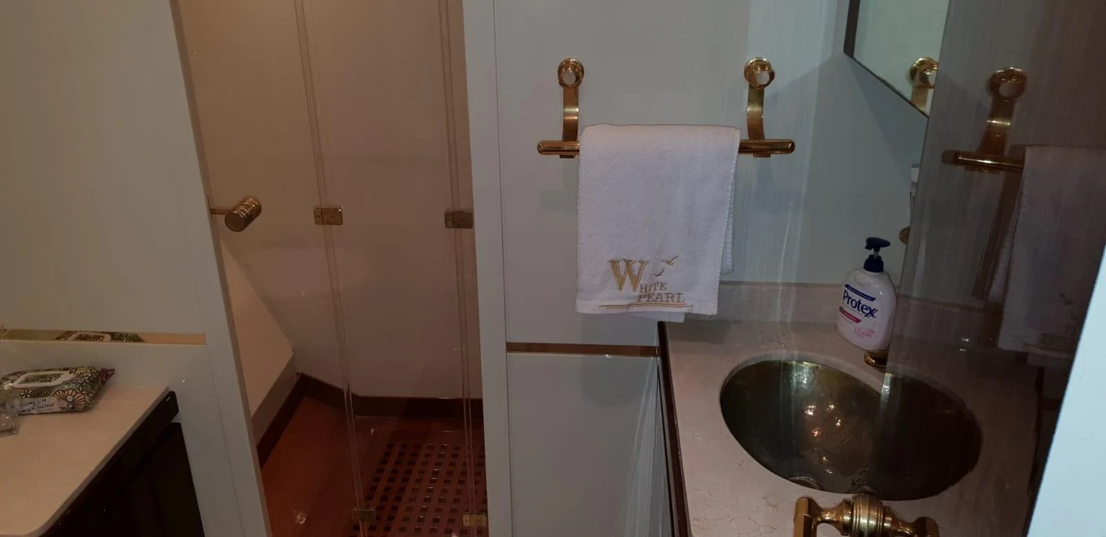 A well-appointed yacht bathroom featuring a glass-enclosed shower and a sleek sink area. aboard LEOPARD 105 FT Yacht for Sale