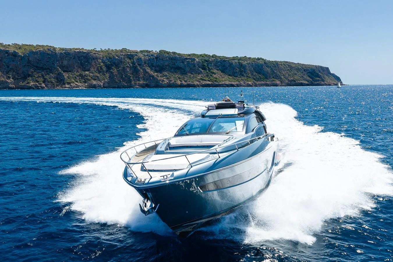 A sleek yacht glides swiftly through the open sea, leaving a trail of white foam in its wake. aboard ACQUA Yacht for Sale
