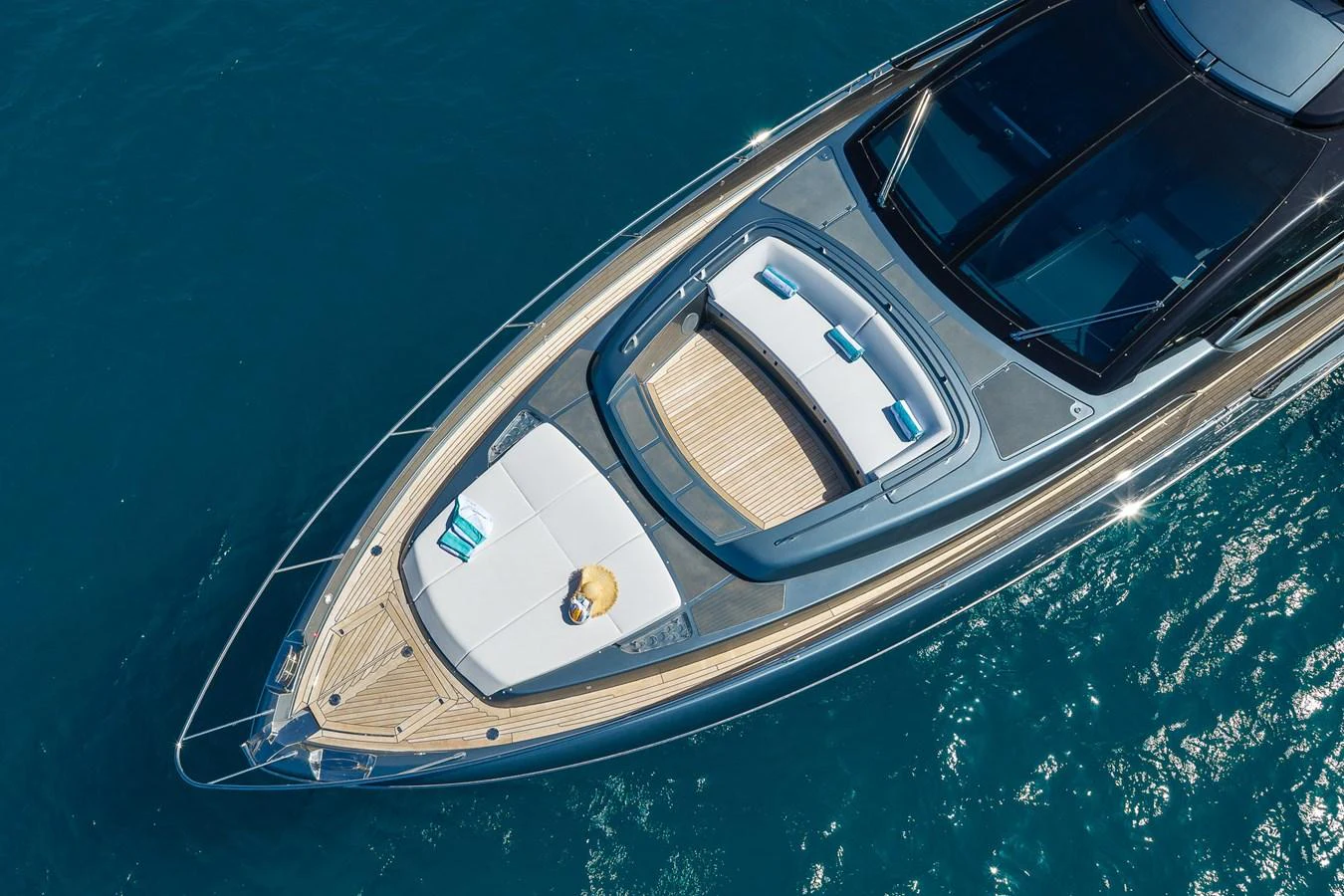 The yacht's foredeck features a spacious sunbathing area with plush cushions and a sleek design. aboard ACQUA Yacht for Sale