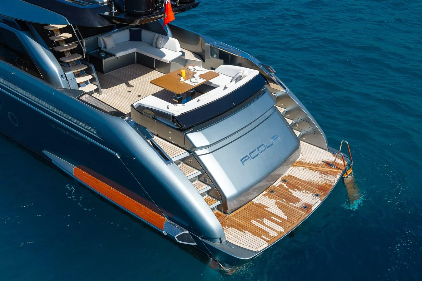 The yacht's aft deck features a luxurious lounging area with direct access to the water. aboard ACQUA Yacht for Sale