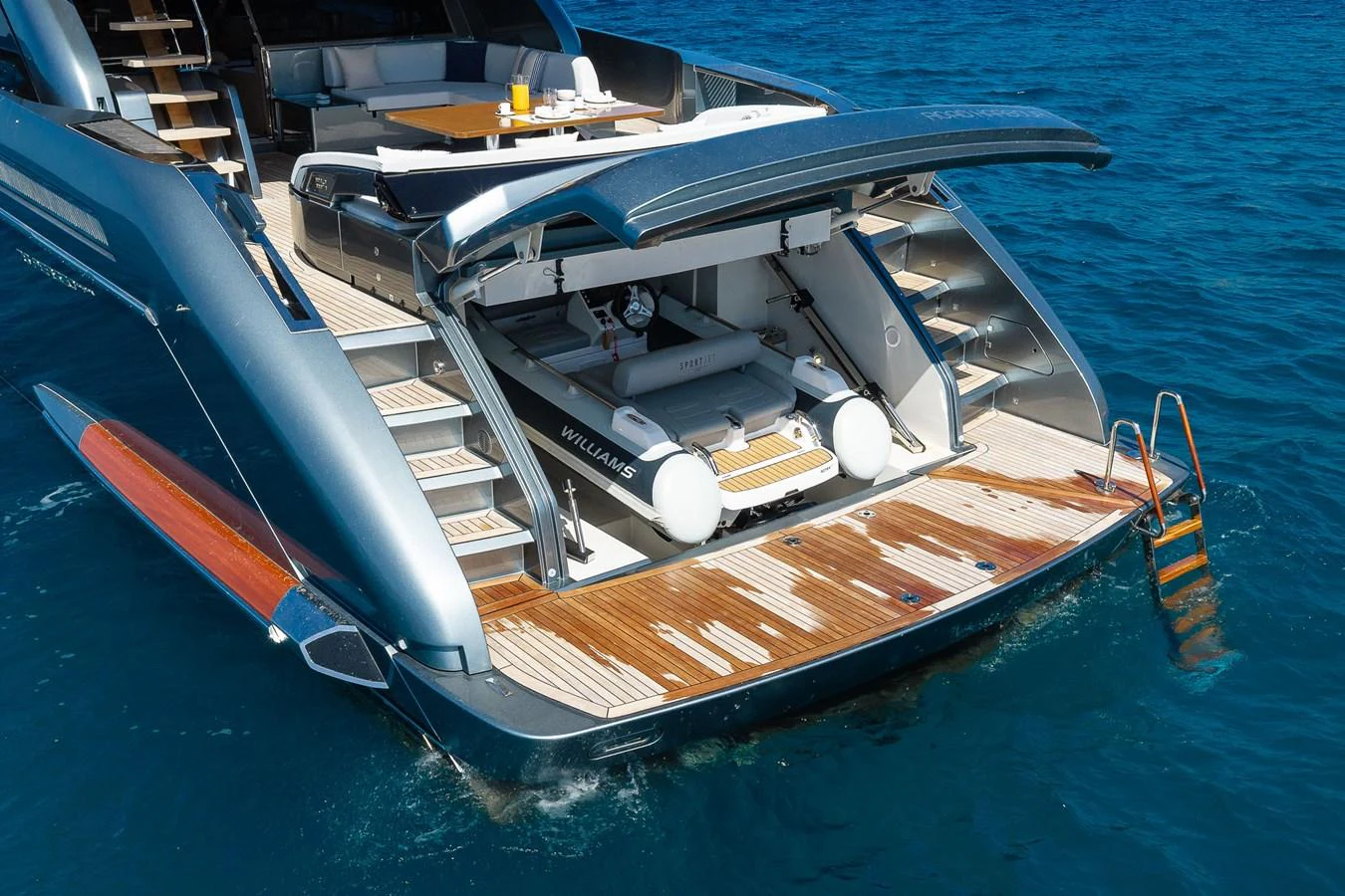The yacht features a sleek tender garage with a Williams tender ready for deployment. aboard ACQUA Yacht for Sale