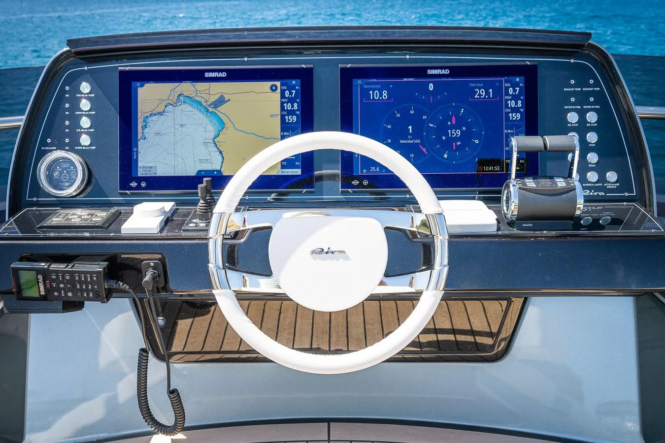 The helm station features advanced navigation displays and a sleek steering wheel, offering precise control and modern technology. aboard ACQUA Yacht for Sale