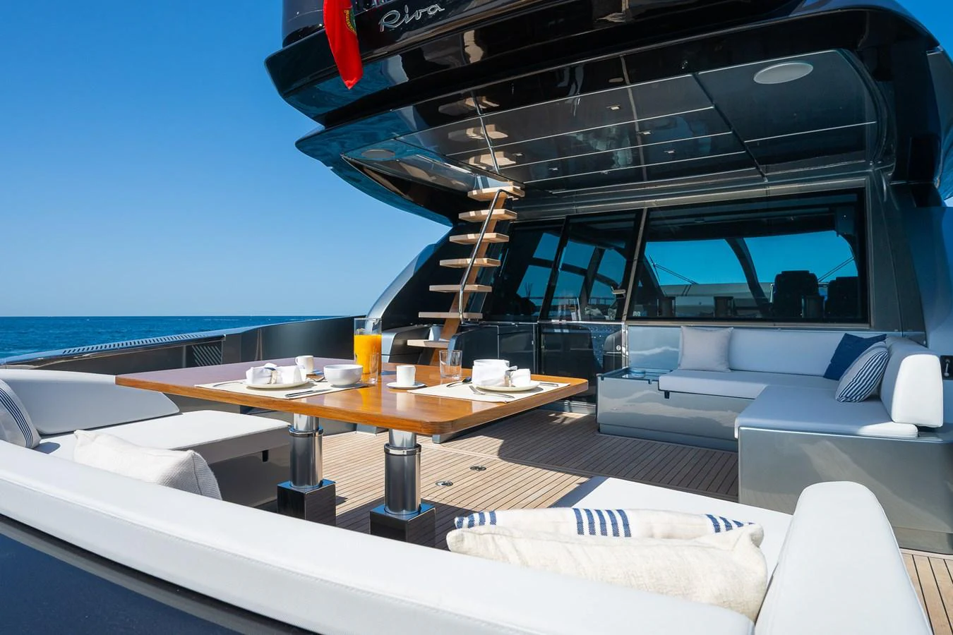 The aft deck offers a luxurious outdoor dining and lounging area with a stunning view of the sea. aboard ACQUA Yacht for Sale