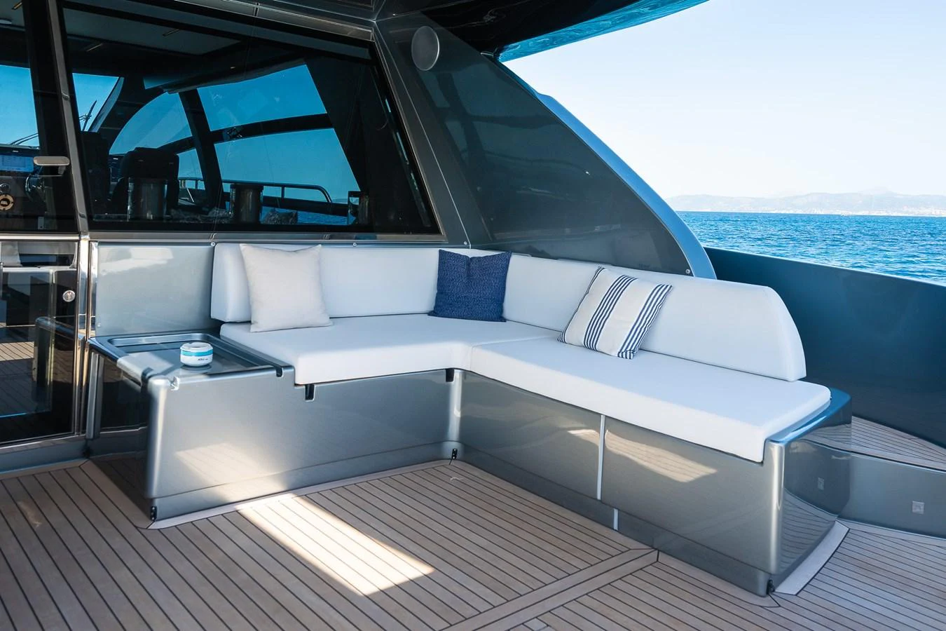 The aft deck features a sleek and comfortable seating area with a stunning ocean view. aboard ACQUA Yacht for Sale