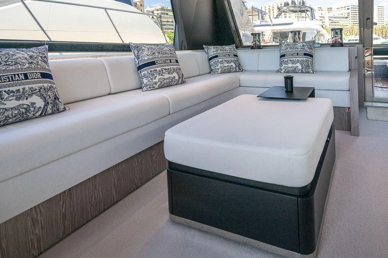 The salon features a luxurious seating area with plush cushions and elegant decor. aboard ACQUA Yacht for Sale