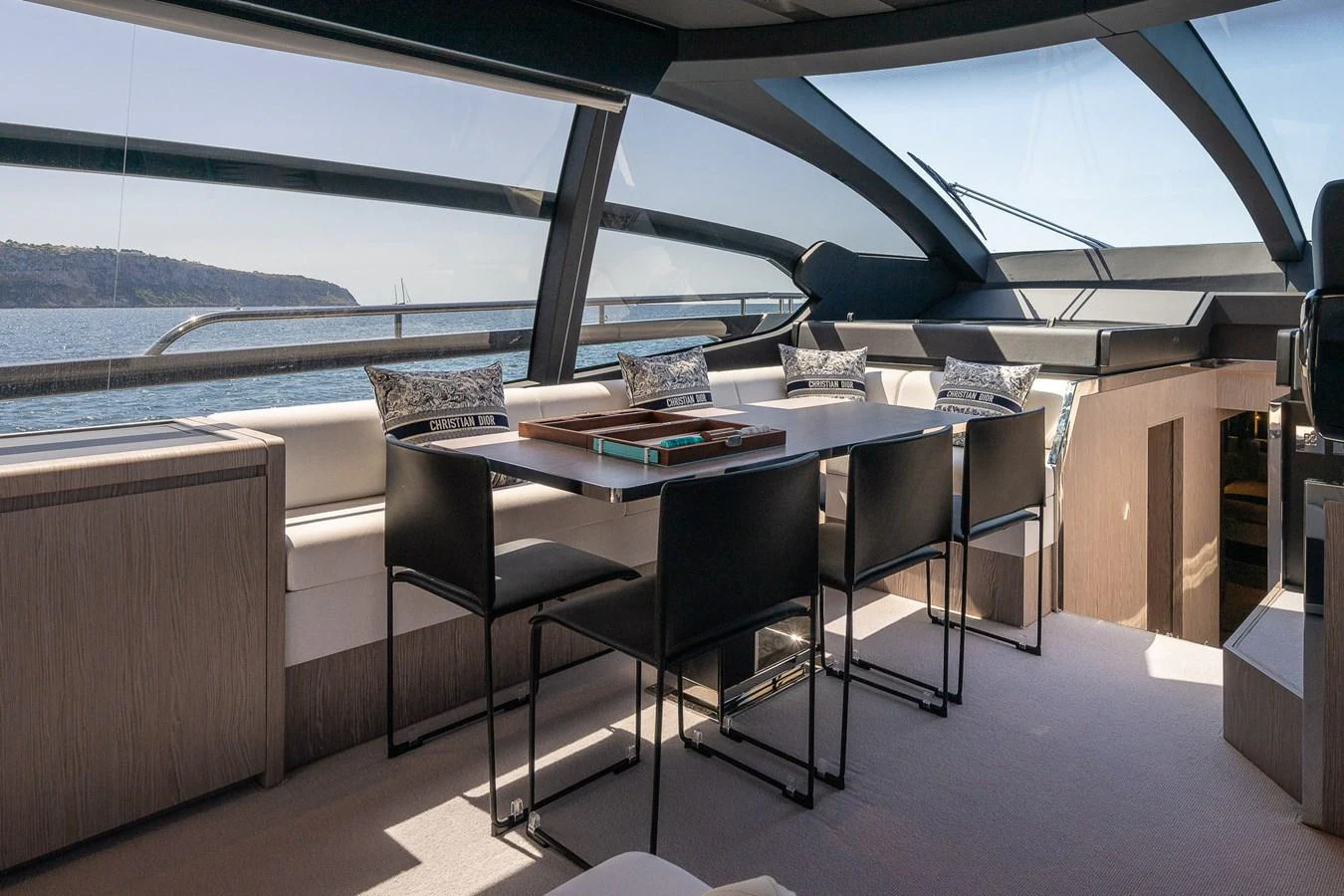The yacht's dining area offers panoramic views with modern seating and elegant design. aboard ACQUA Yacht for Sale
