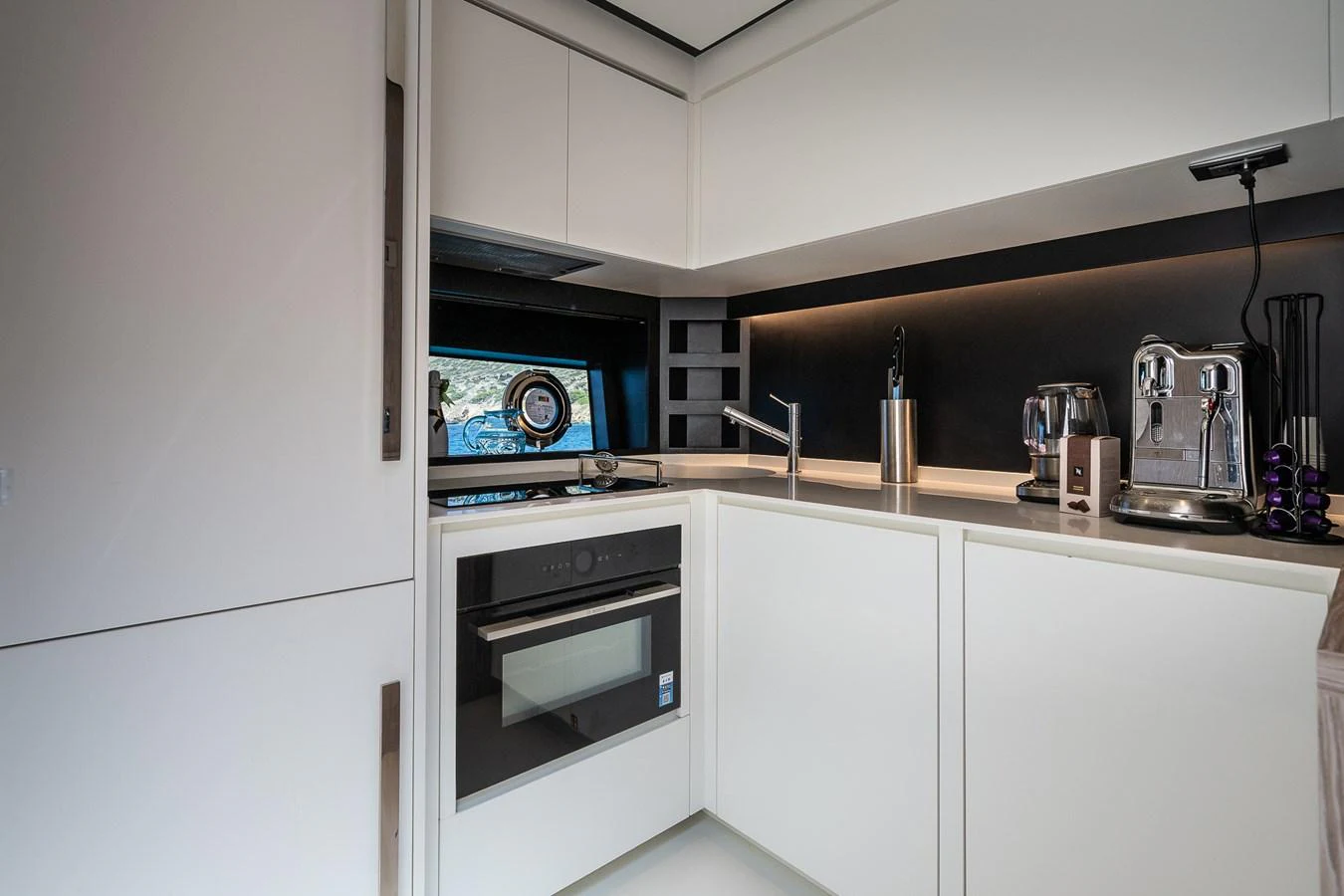 The modern galley is equipped with sleek appliances and ample counter space. aboard ACQUA Yacht for Sale