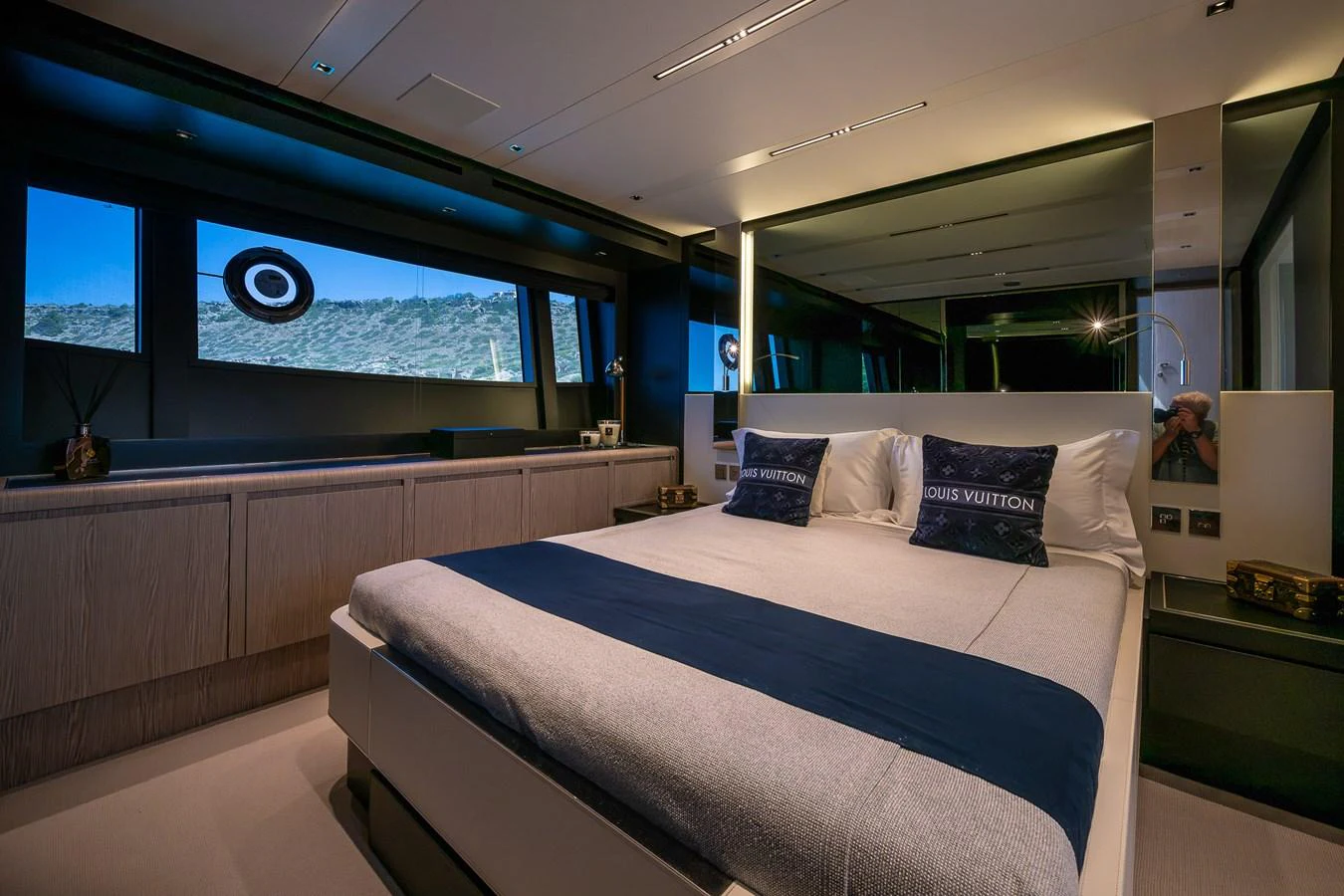 The stateroom features a luxurious bed with elegant linens and ample natural light from large windows. aboard ACQUA Yacht for Sale