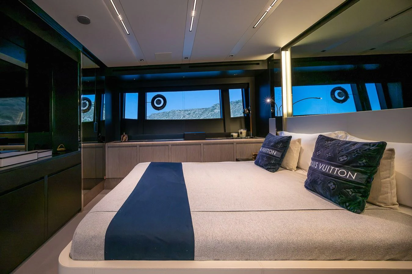 The guest stateroom features a luxurious bed with elegant bedding and modern decor. aboard ACQUA Yacht for Sale
