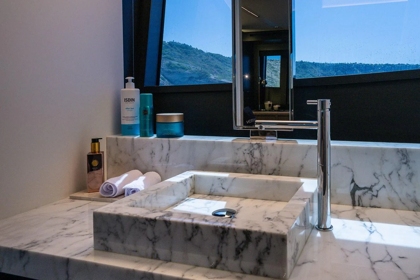 A luxurious bathroom with a marble countertop and modern fixtures. aboard ACQUA Yacht for Sale