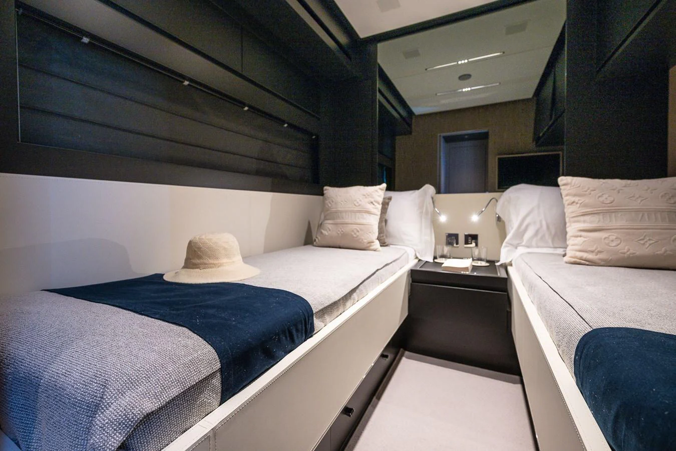 The twin stateroom features two comfortable beds with elegant bedding and a cozy ambiance. aboard ACQUA Yacht for Sale