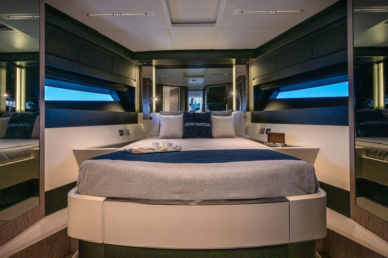 The stateroom features a luxurious bed with elegant bedding and modern lighting. aboard ACQUA Yacht for Sale