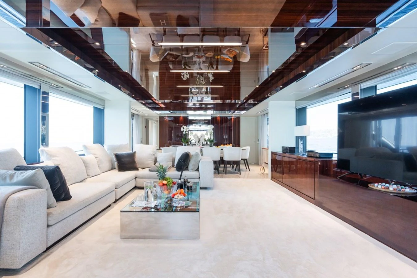 The spacious salon features luxurious seating, a modern entertainment system, and elegant decor. aboard JANETTE Yacht for Sale