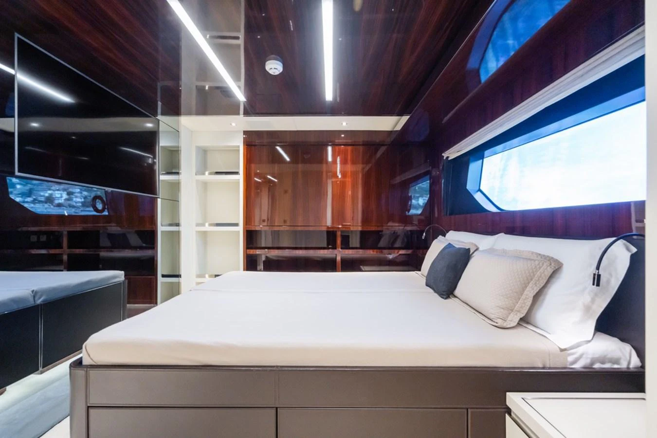 The stateroom features a luxurious bed with modern decor and ample natural light. aboard JANETTE Yacht for Sale