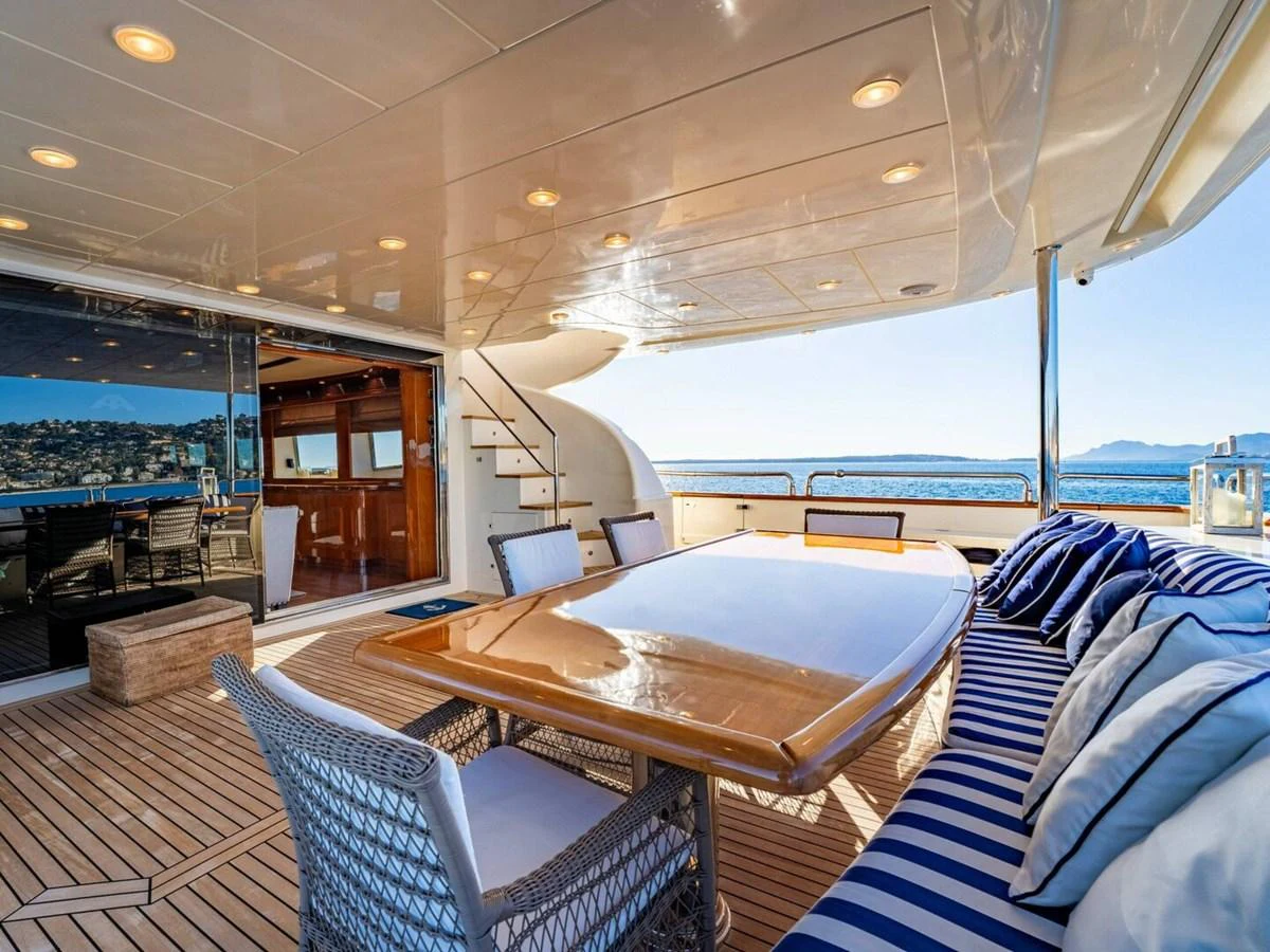 The aft deck offers a luxurious outdoor dining area with stunning sea views. aboard SPRING TIDE Yacht for Sale