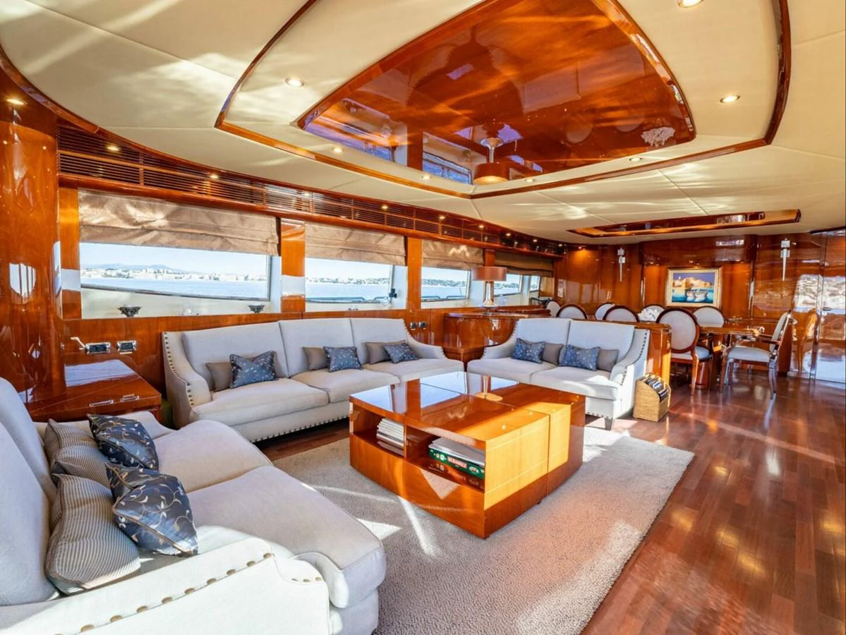 The yacht's salon features luxurious seating and elegant wood finishes, creating a warm and inviting atmosphere. aboard SPRING TIDE Yacht for Sale