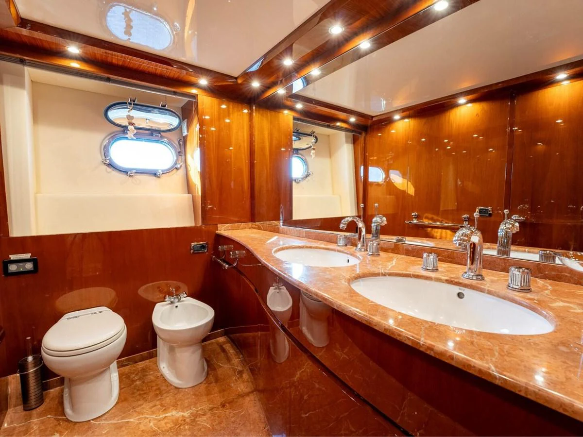 The yacht's bathroom features luxurious fixtures and a polished wood finish. aboard SPRING TIDE Yacht for Sale