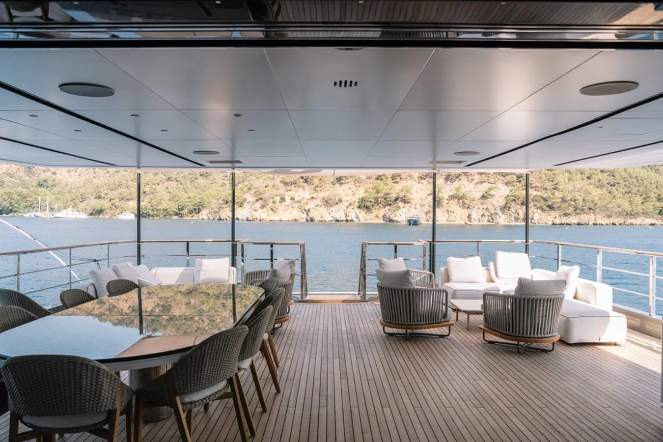 The aft deck offers a spacious and luxurious outdoor seating area with stunning views. aboard RAISA Yacht for Sale