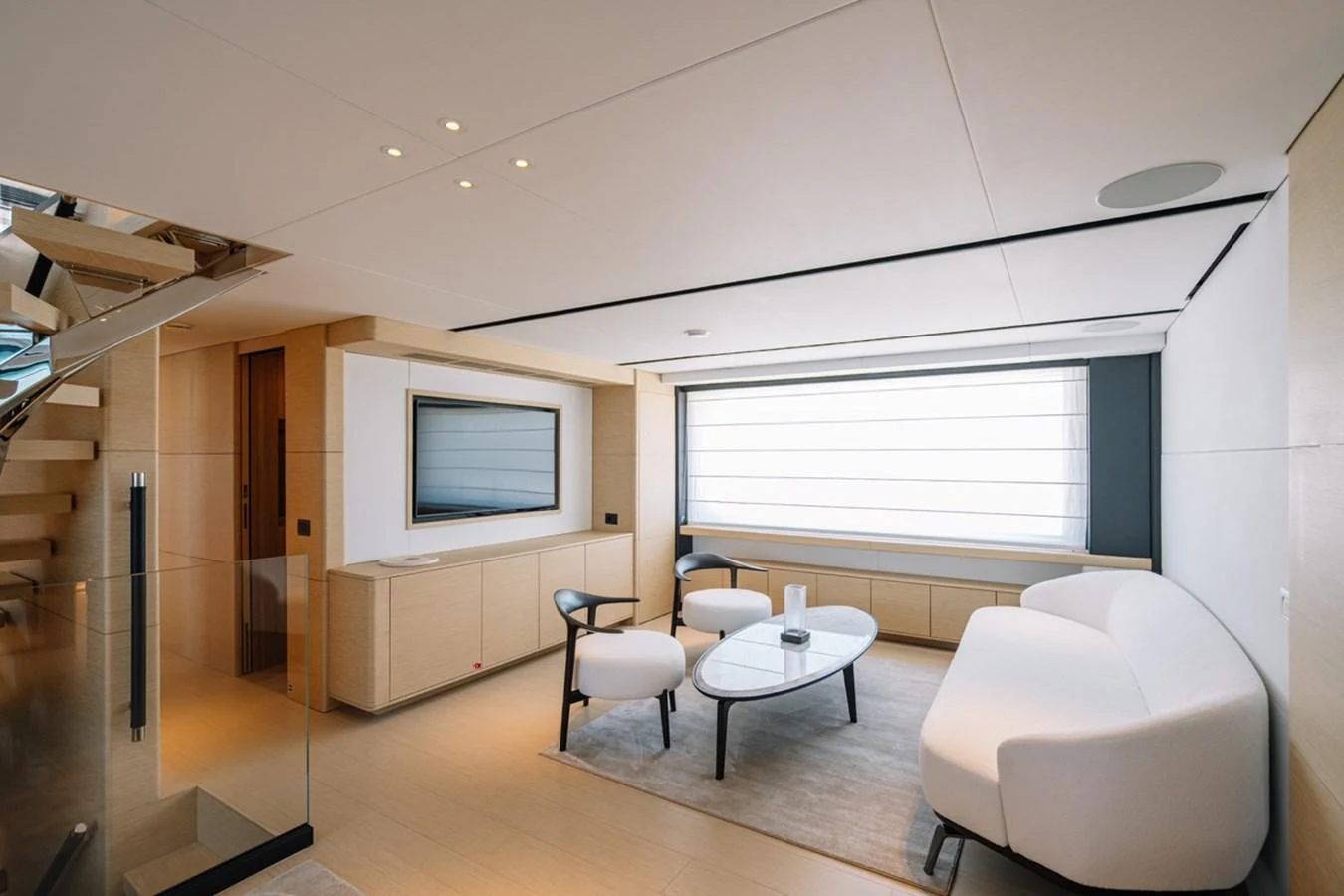The salon features modern furnishings with a neutral color palette and ample natural light. aboard RAISA Yacht for Sale