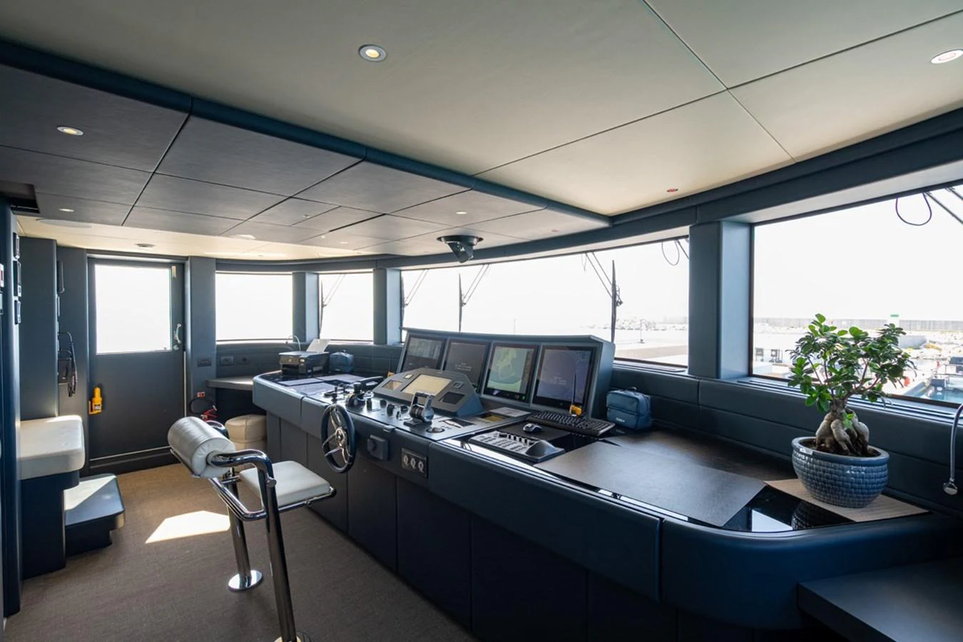 The helm station features advanced navigation equipment and a comfortable captain's chair. aboard RAISA Yacht for Sale