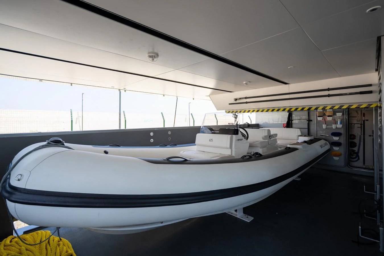 The image showcases a well-maintained tender stored in a dedicated garage area of the yacht. aboard RAISA Yacht for Sale