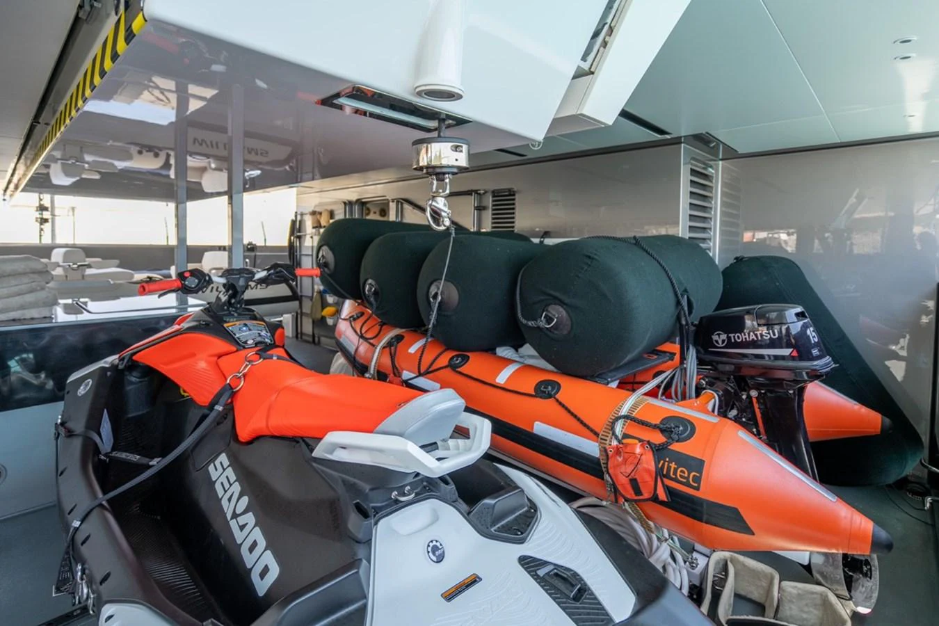 The yacht's tender garage houses a variety of watercraft, including a Sea-Doo and an inflatable boat. aboard RAISA Yacht for Sale